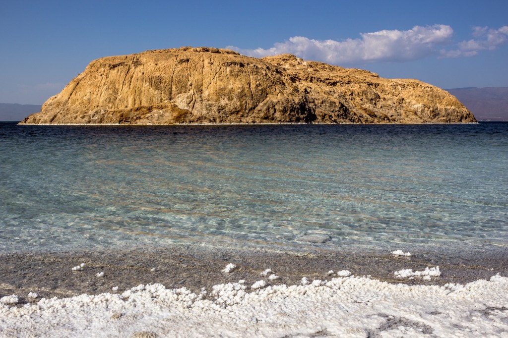 The salt can be seen on the shore at Lac Assal.  It's solid and sharp enough to cut yourself on.