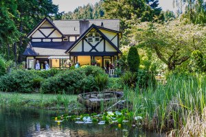 an old English Tudor style house hosts viewers of its flower garden