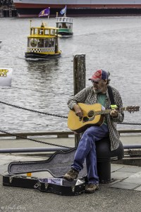 busker with a guitar and open case