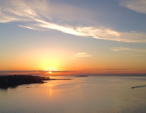a warm orange sunrise blankets the Pacific