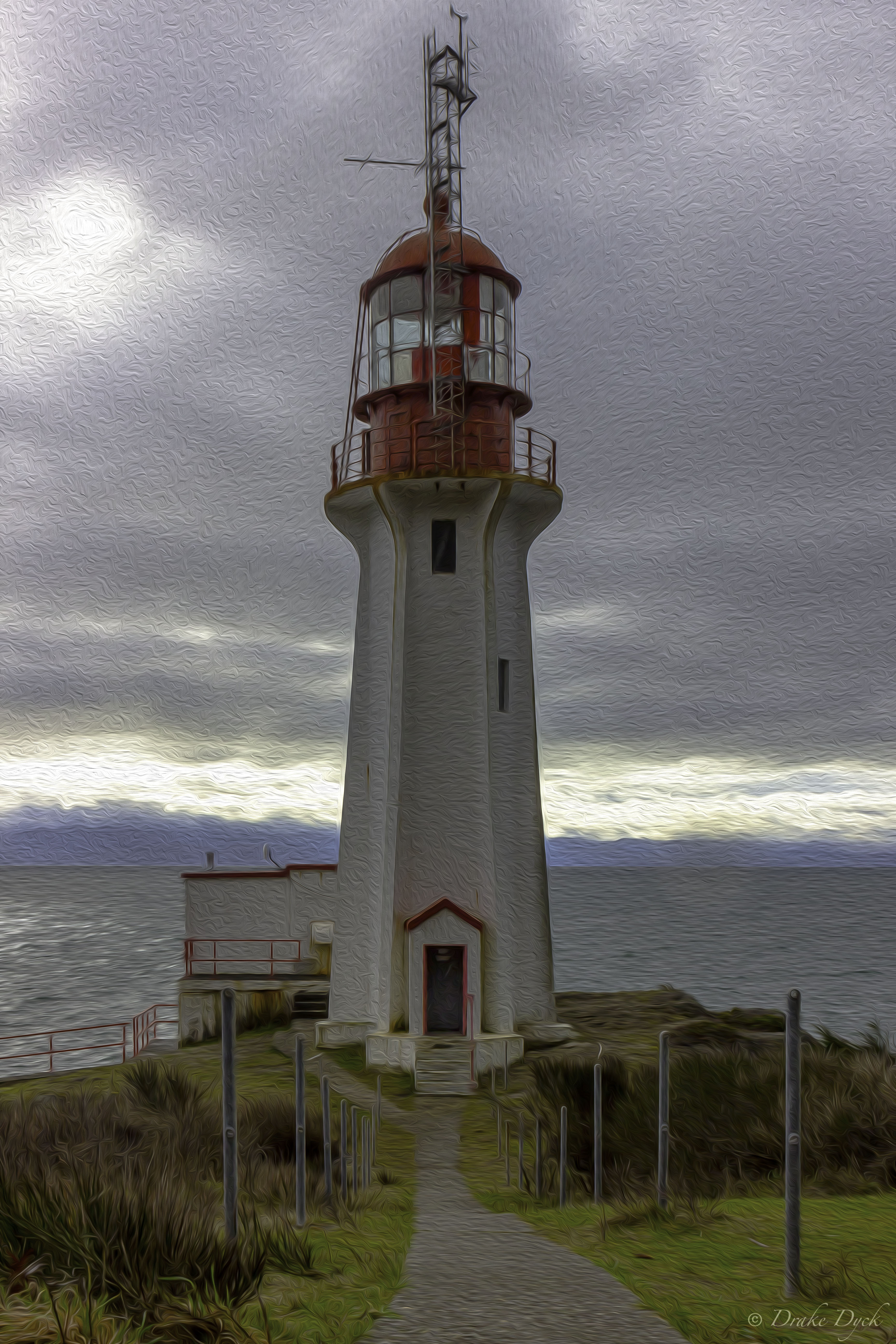 old lighthouse on an overcast day at the end of a path