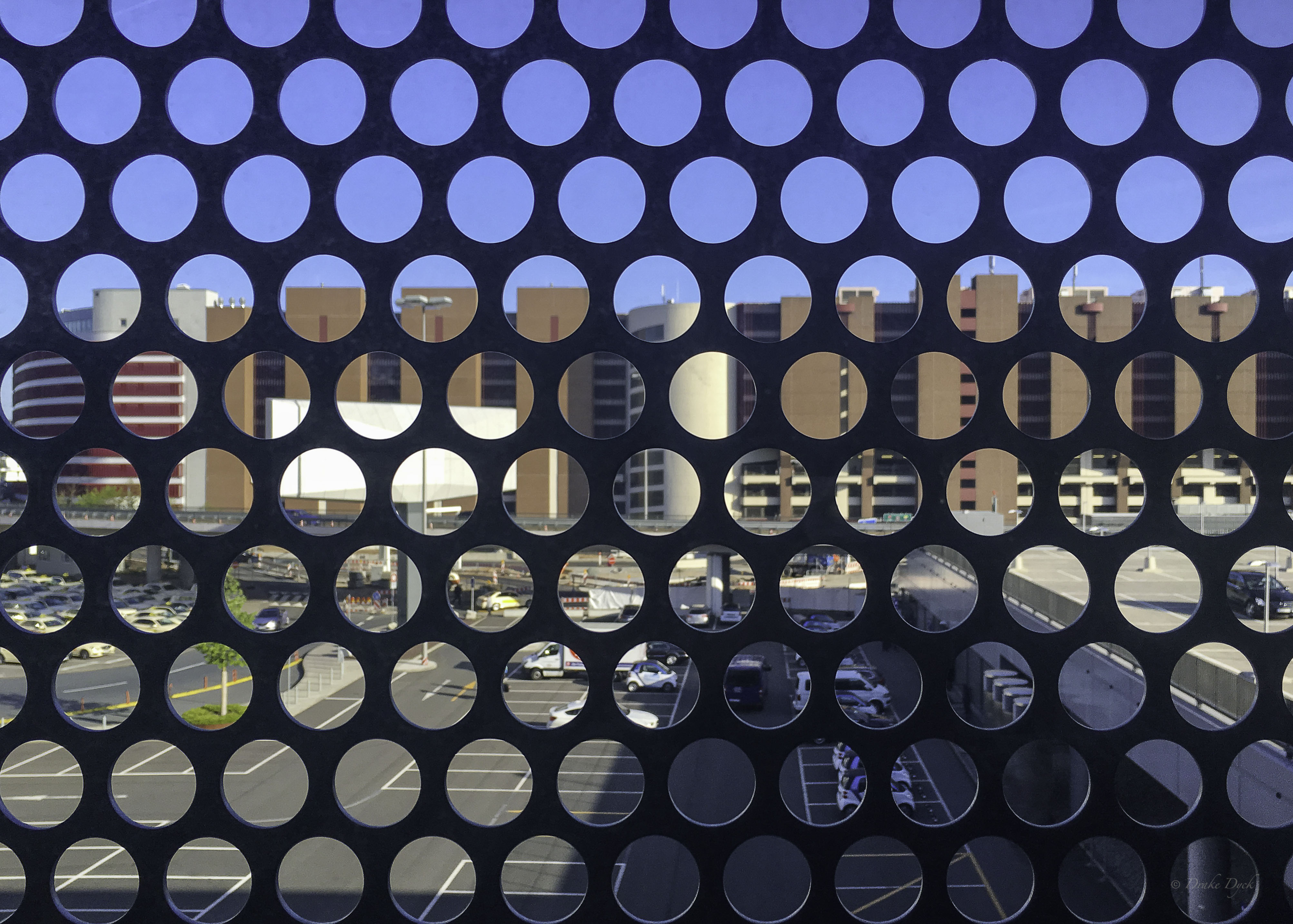 looking through window grate holes at the airport in Bucharest