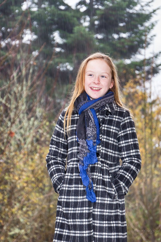 young girl standing in the rain