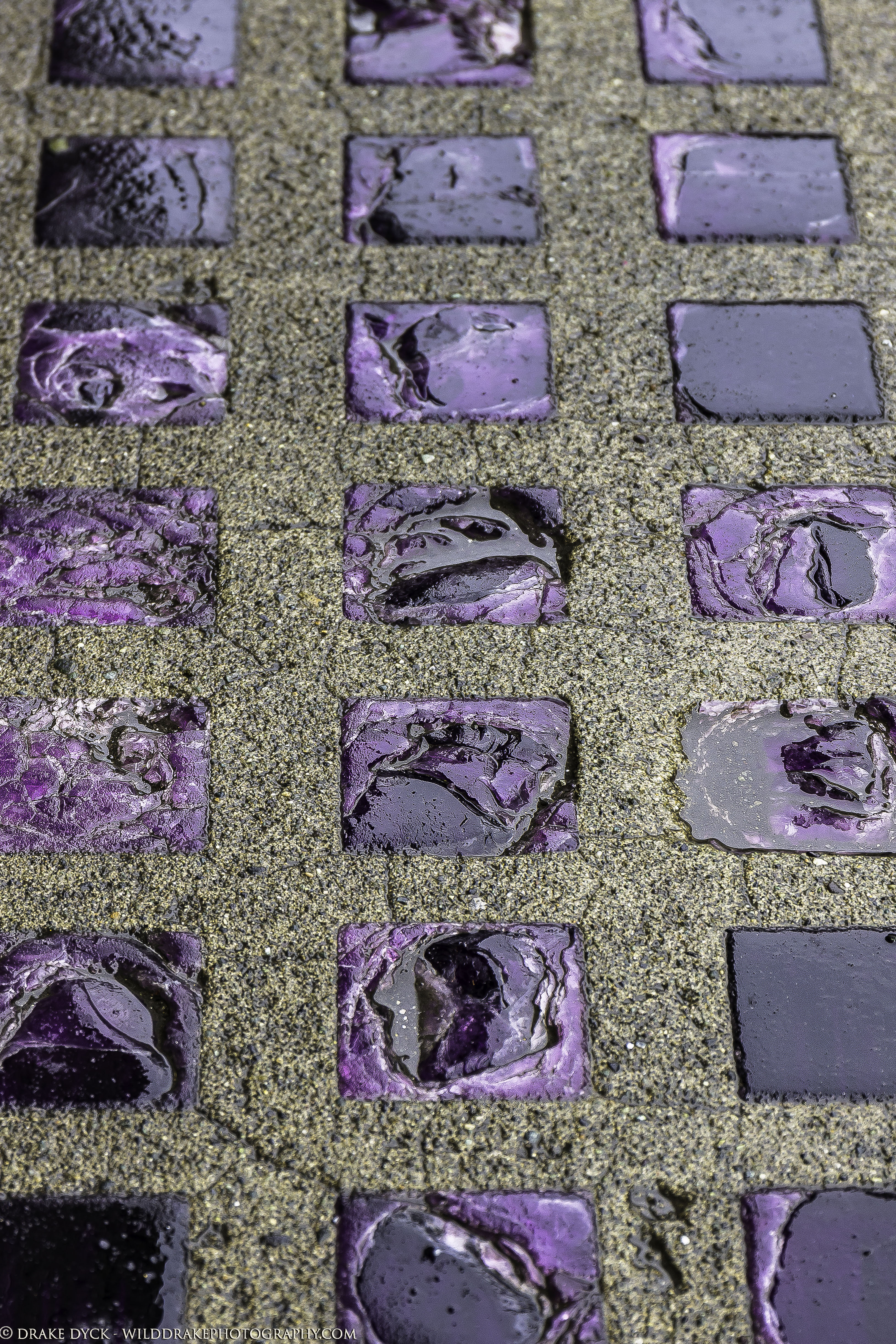 Purple rock squares inlaid in the sidewalk
