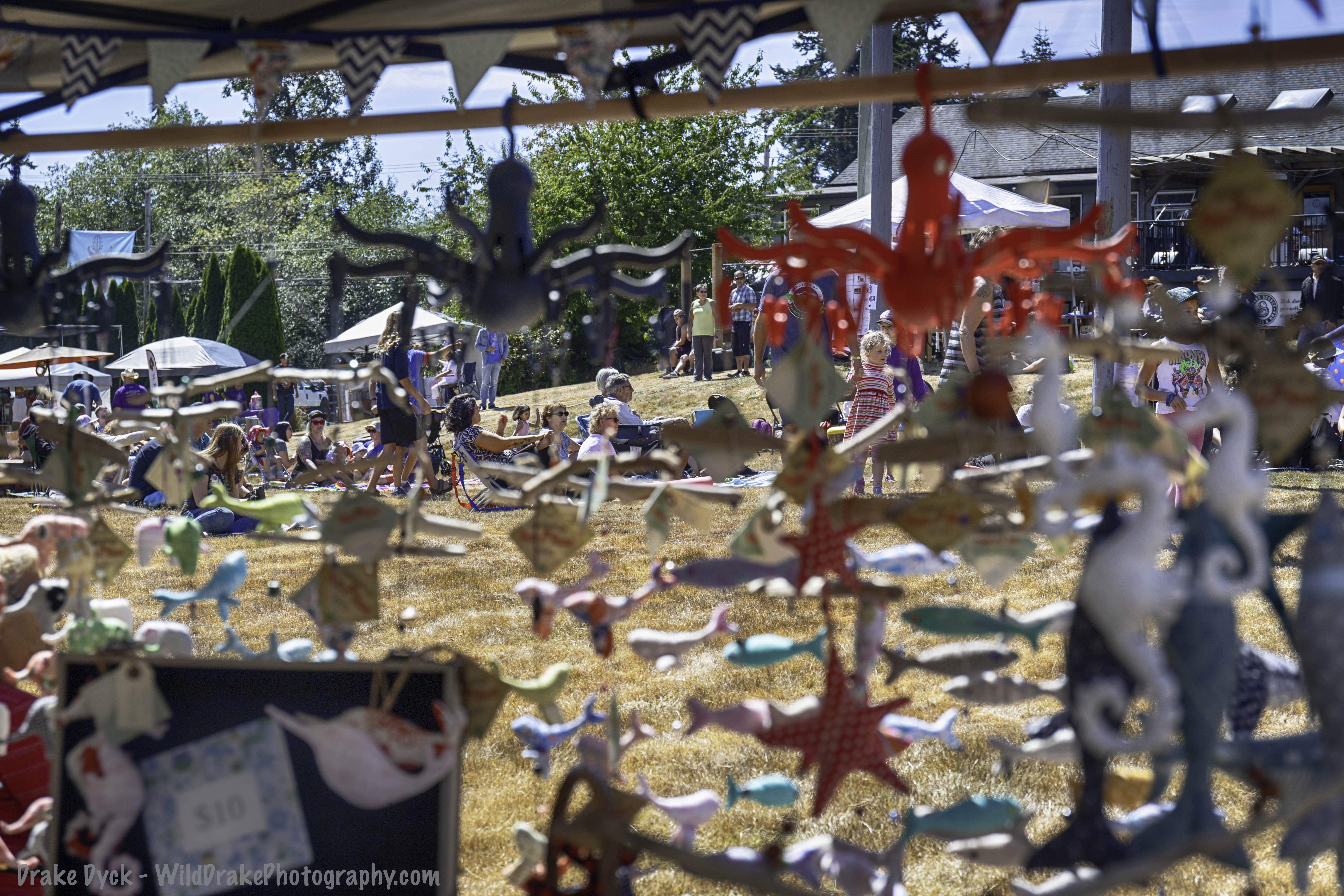 people on the grass viewed through hanging art